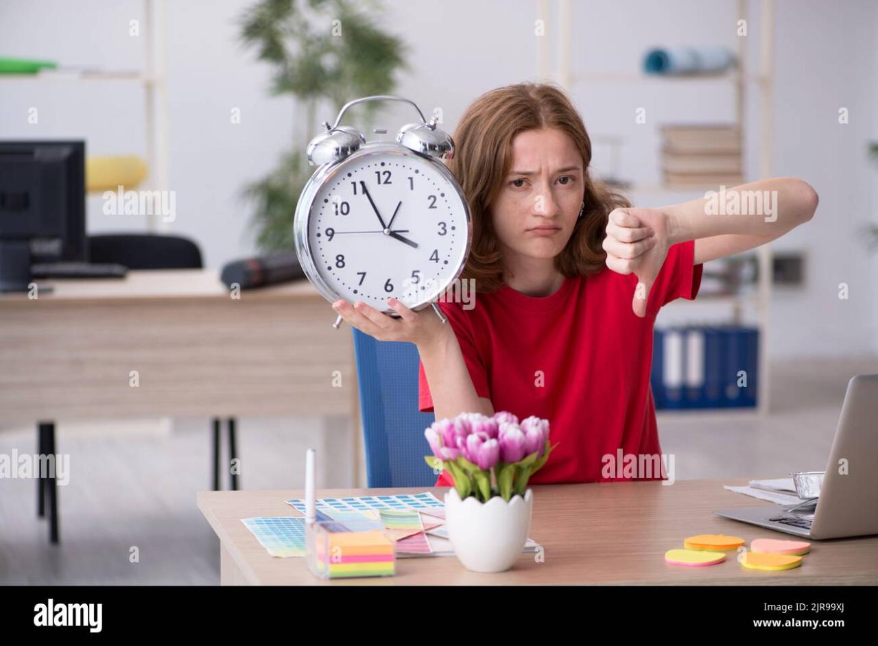 Female designer in time management concept Stock Photo - Alamy